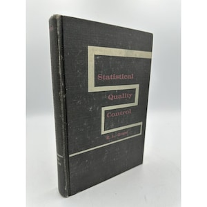 May include: A black book with the title "Statistical Quality Control" by E. L. Grant. The title is in a white box with a red border.