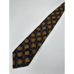 May include: A patterned necktie featuring a repeating square design. The squares are black with a brown and gold floral pattern. The tie is angled against a white background.