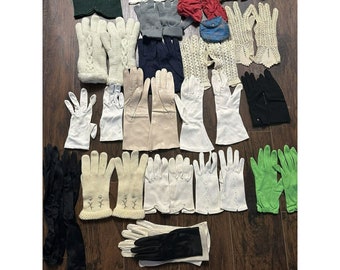 May include: A collection of vintage gloves in various colors and styles, including white, black, green, and red. The gloves are made of different materials, such as lace, leather, and fabric. Some of the gloves have decorative details, such as embroidery or beading.