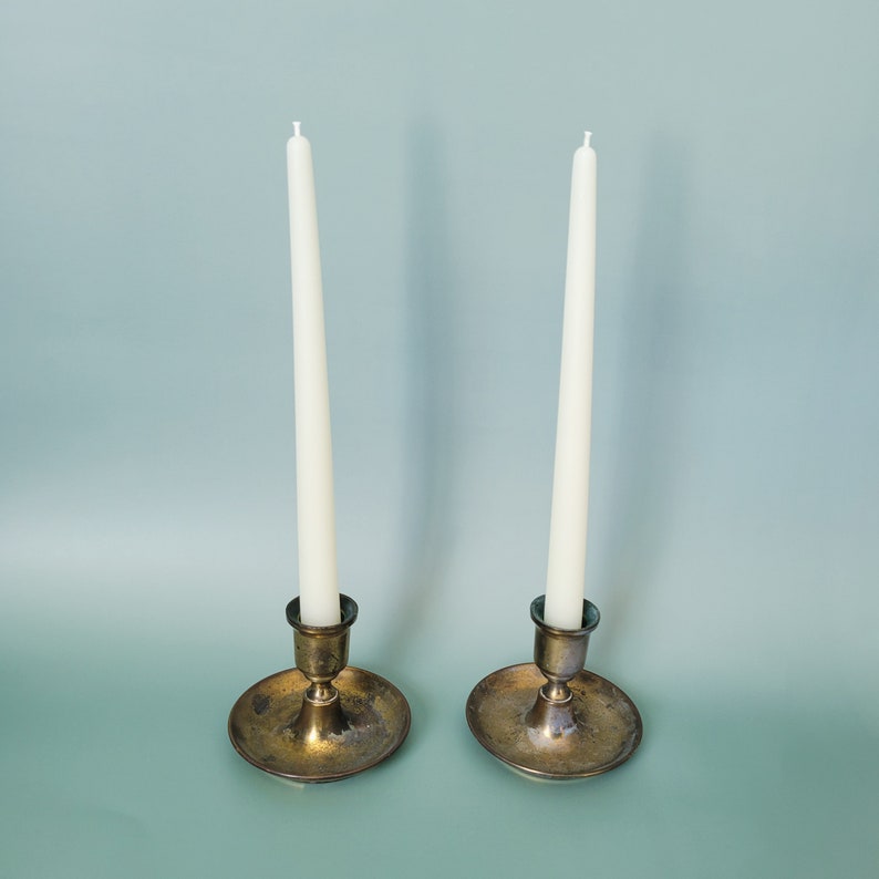 Handmade Beeswax Candle Taper with a Pure Cotton Wick. Candles are set in antique candle holders and are pure white. This is Happy Little Herbs Pure variant.