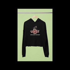 May include: Black cropped hoodie with a red and white logo that says "Wolf Cola" and "Official Drink of Bokob Haram".