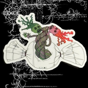 May include: A whimsical sticker featuring two cartoon figures intertwined on a white candy wrapper. One figure is green with green hair, the other is pink with orange hair. The figures are wrapped in a green and purple rope.