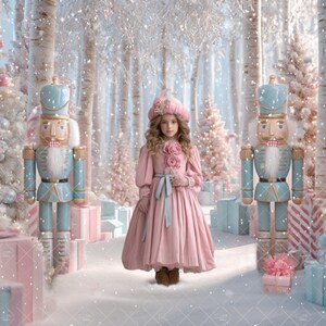 May include: A young person in a pink dress and hat stands between two blue and wooden nutcrackers in a snowy forest scene. Pink and blue wrapped gifts and Christmas trees are in the background. The scene is a winter wonderland.