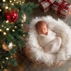 May include: A newborn baby wrapped in a white blanket, nestled in a fluffy, white, woven basket. The basket is on a wooden surface, with a Christmas tree and wrapped gifts in the background. The scene is lit with warm, soft lighting.