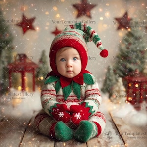 May include: A baby dressed in a Christmas elf outfit, including a red and green hat, mittens, and booties. The outfit has a red and white striped pattern. The baby is sitting on a wooden surface with a snowy background, surrounded by Christmas decorations.