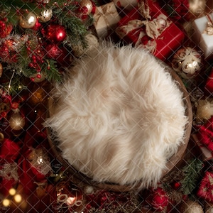 May include: A festive Christmas-themed newborn photography prop setup. Features a wooden bowl filled with fluffy cream-colored faux fur, surrounded by red and gold ornaments, wrapped gifts, and evergreen branches.