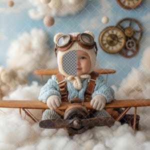 May include: A baby dressed in a vintage aviator outfit, complete with a knit cap with goggles, a blue sweater, and a brown leather harness. The baby is seated in a wooden toy airplane, surrounded by fluffy white clouds and a blue sky background.