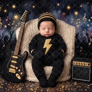 May include: A sleeping infant wearing a black knit onesie with a gold lightning bolt emblem and a matching striped beanie, seated in a cream-coloured chunky knit chair next to a black electric guitar and a small black amplifier with gold accents.