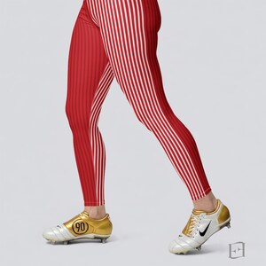 May include: Red and white striped leggings with vertical stripes. The leggings are worn with gold and white football boots. The boots have the number "90" on the side. The leggings are close-fitting.