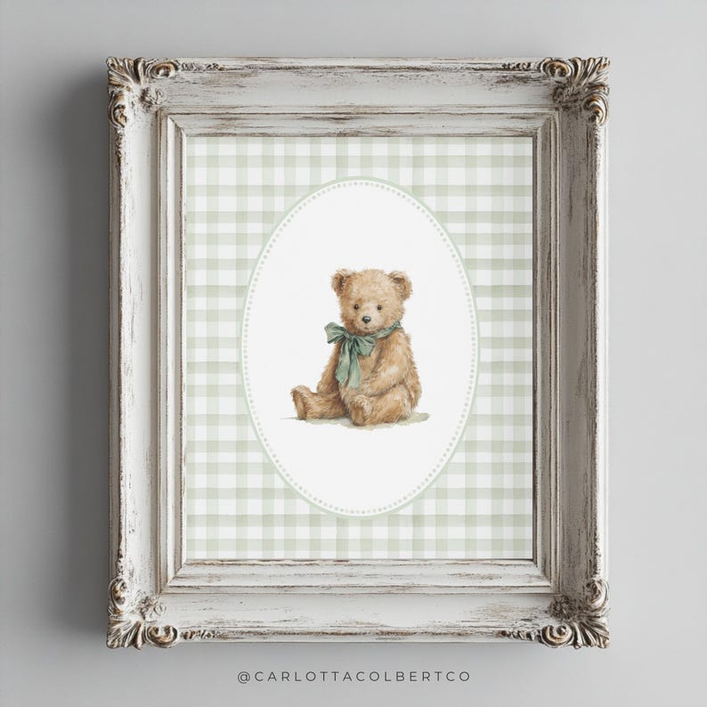 May include: A framed print featuring a watercolor illustration of a teddy bear with a green bow. The bear is set against a green and white gingham pattern within an oval frame. The frame is white with ornate detailing.