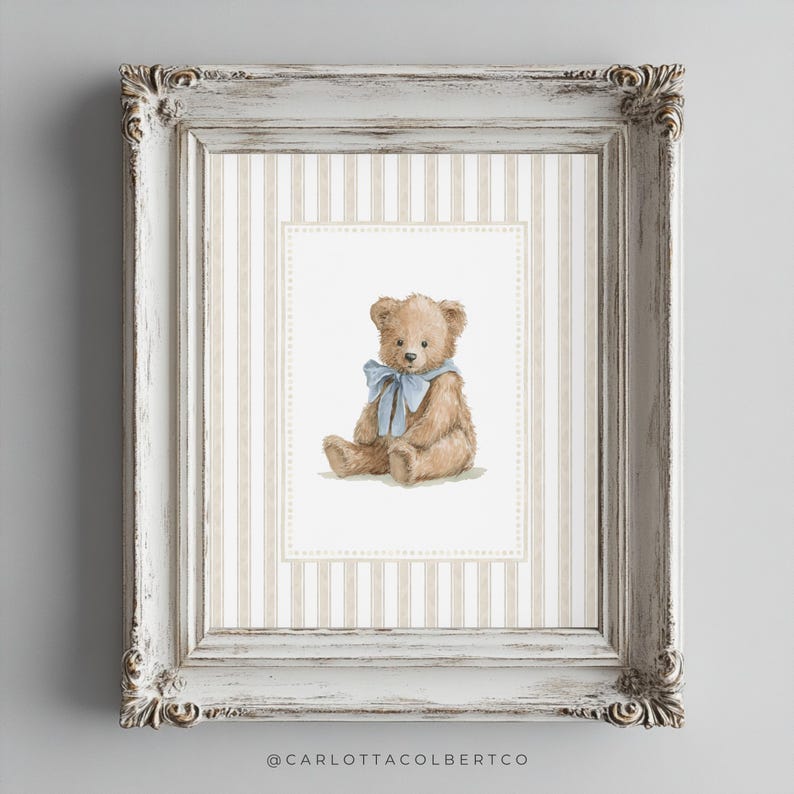 May include: A framed print featuring a watercolor illustration of a teddy bear with a blue ribbon. The bear is set against a striped background within a white ornate frame. The artwork has a vintage aesthetic.