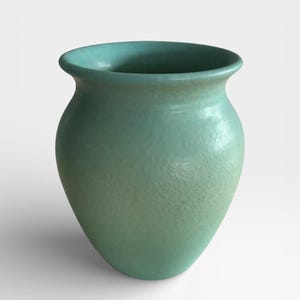 May include: A set of three ceramic mugs with a speckled, matte finish. The mugs are in shades of cream, light gray, and dark gray. Each mug has a simple, minimalist design and a rounded handle.