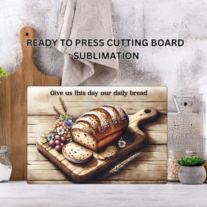 May include: A rectangular cutting board with a bread loaf illustration. The image features a loaf of bread on a wooden cutting board, with the text "Give us this day our daily bread". The words "READY TO PRESS CUTTING BOARD SUBMLIMATION" are also visible.