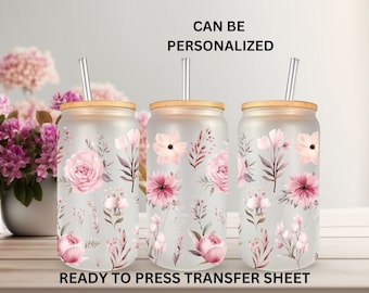 May include: Three frosted glass tumblers with bamboo lids and clear straws, each featuring a pink floral design. The tumblers are ready to press transfer sheets, allowing for personalization. "CAN BE PERSONALIZED" and "READY TO PRESS TRANSFER SHEET" text is visible.