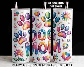 May include: A white 20 oz skinny straight tumbler with a colorful design. The tumbler features paw prints, hearts, and flowers in rainbow hues, with the words "DOG MOM" in a tie-dye style. The text "READY TO PRESS HEAT TRANSFER SHEET" is at the bottom.