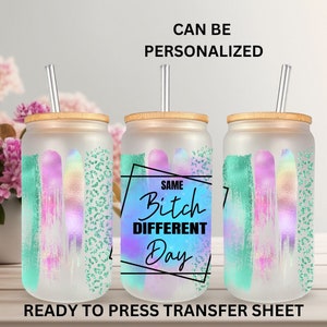 May include: Three sublimation ready to press transfer sheets with a design of a rainbow and green brushstrokes. The center sheet has the text "Same Bitch Different Day" in a black square.