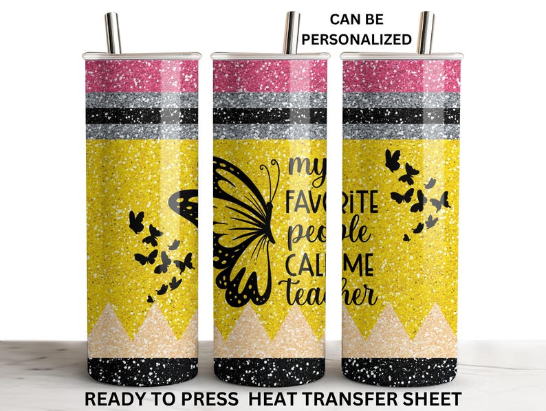 May include: A yellow glitter tumbler with a black butterfly and the text "my favorite people call me teacher". The tumbler has a pink glitter top and black and silver glitter stripes.
