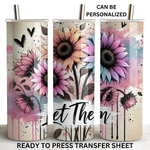 May include: A sublimation design featuring a watercolor background with pink, blue, and yellow sunflowers. The text "Let Them" is printed on the design. This design is ready to be pressed onto a tumbler.