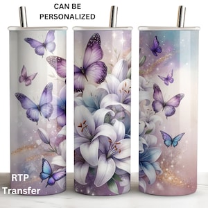 May include: A set of three stainless steel tumblers with a purple and white floral design featuring butterflies. The tumblers have a silver lid and straw. The text "CAN BE PERSONALIZED" is at the top of the image. The text "RTP Transfer" is at the bottom of the image.