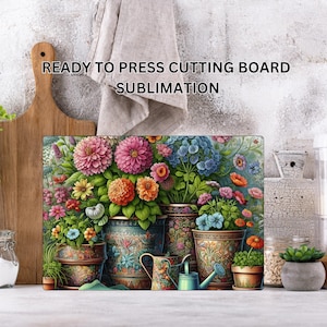 May include: A rectangular cutting board featuring a vibrant floral print with various potted flowers, including pink dahlias and blue hydrangeas, alongside a small watering can. The text READY TO PRESS CUTTING BOARD SUBLIMATION is visible above.
