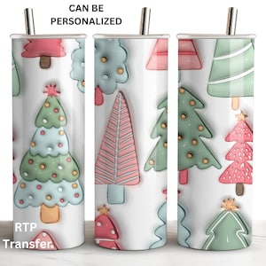 May include: Three stainless steel tumblers with a white background and a pattern of colorful Christmas trees. The text "CAN BE PERSONALIZED" is at the top of the image. The text "RTP Transfer." is at the bottom of the image.