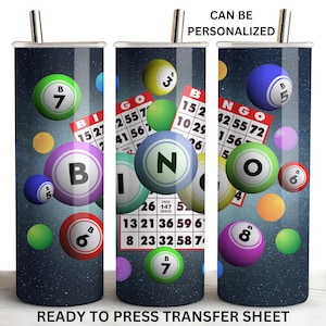 May include: A sublimation design featuring a bingo card and bingo balls with numbers on a dark blue background. The design is ready to be pressed onto a tumbler.
