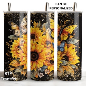 May include: A black and gold tumbler with a design of sunflowers, butterflies, and gold glitter. The tumbler is 20 ounces and has a straw.
