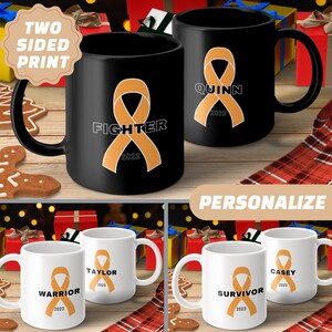 May include: Set of four black and white ceramic mugs with orange ribbon designs. The mugs feature the words "Warrior", "Fighter", "Survivor", and "Quinn" with the year 2023. The mugs are personalized with names and are ideal for gifts.