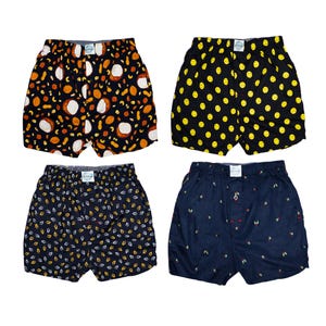 May include: Four pairs of boxer shorts with various patterns. One pair has a black background with white and orange fruit designs. Another has a black background with yellow smiley faces. The third pair has a navy background with white and yellow leaf designs. The last pair has a navy background with small green fruit designs.