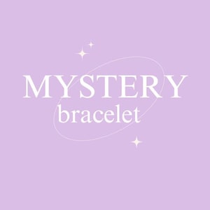 May include: A light purple background with the words "MYSTERY bracelet" in white, with a white oval shape around the word "MYSTERY". There are two small starbursts. The image is for a bracelet.