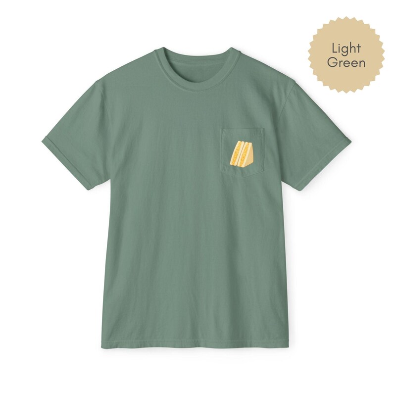 Tamago sando pocket t shirt in light green with egg sandwich print on chest pocket