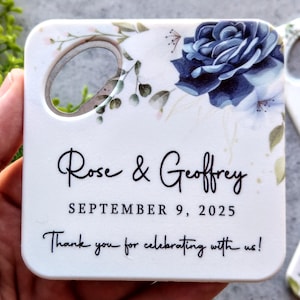 Puede incluir: Abrebotellas de cerámica blanca con un diseño floral azul y el texto "Rose & Geoffrey September 9, 2025 Thank you for celebrating with us!"