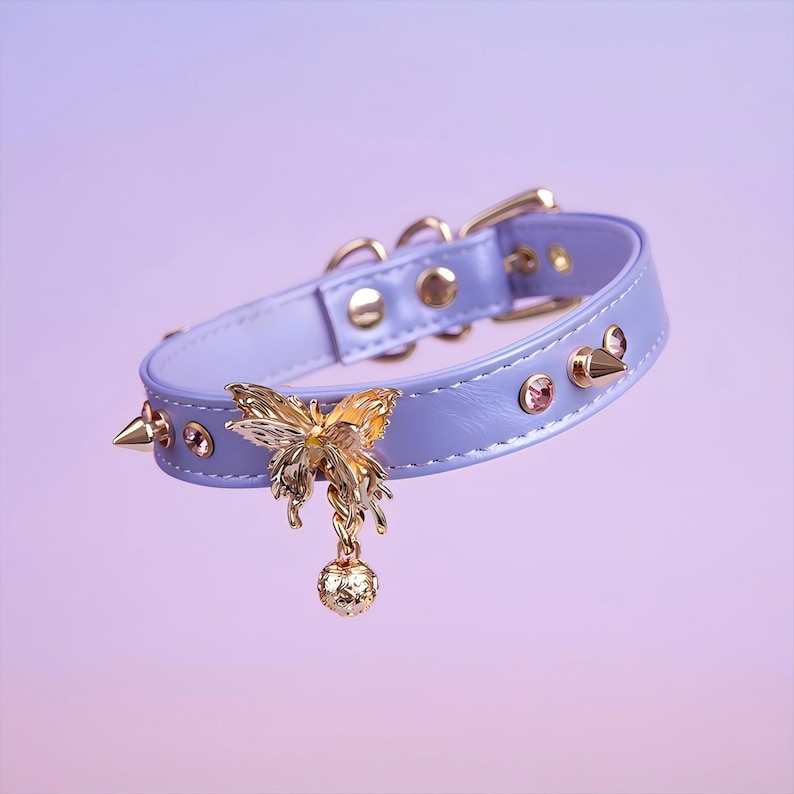 May include: A lavender leather choker with gold studs and a gold butterfly charm with a dangling ball.