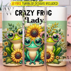 Könnte beinhalten: Drei Edelstahlbecher mit einem grünen Frosch, der eine Brille trägt, und einem Sonnenblumendesign. Der Text "CRAZY FROG Lady" ist auf dem mittleren Becher aufgedruckt.