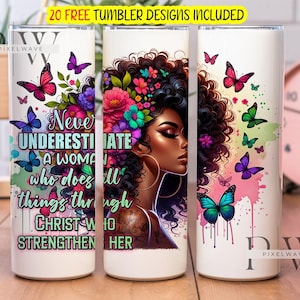 May include: White tumbler with a design of a woman with flowers in her hair and butterflies. The text on the tumbler reads "Never underestimate a woman who does all things through Christ who strengthen her."