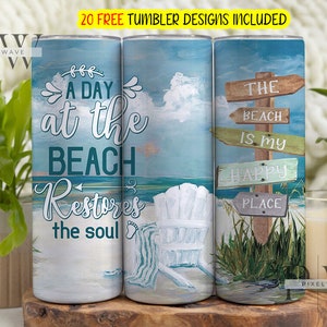 May include: Three stainless steel tumblers with beach-themed designs. The first tumbler features a blue and green watercolor design with the text "A day at the beach restores the soul". The second tumbler features a blue and white watercolor design with a beach chair and a towel. The third tumbler features a blue and green watercolor design with a wooden sign that reads "The beach is my happy place".