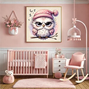 May include: A framed illustration of a cartoon owl wearing a pink nightcap, perched on a branch. The owl has large, expressive eyes and is surrounded by soft, pastel colours. The word "z" is repeated above the owl. The image is in a pink nursery.