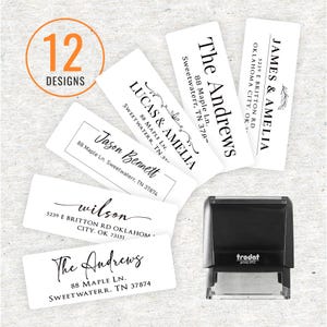 May include: A black Trodat Printy 4913 self-inking stamp positioned next to five rectangular white address labels. Each label features different black text designs with names and addresses, including The Andrews, Lucas & Amelia, and Jason Bennett. An orange circle with the text 12 DESIGNS is visible in the upper left corner.