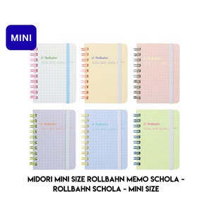 May include: Six mini Rollbahn memo notebooks in pastel colors: white, yellow, pink, lavender, blue, and green. Each notebook has a spiral binding, a grid pattern, and a matching elastic band. The text "Rollbahn" is printed on each cover. The word "MINI" is in a blue box.