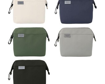 May include: Five rectangular cosmetic bags in different colors: off-white, navy blue, olive green, light gray, and black. Each bag has a zipper closure, a small rectangular label, and a black carabiner clip on each side.