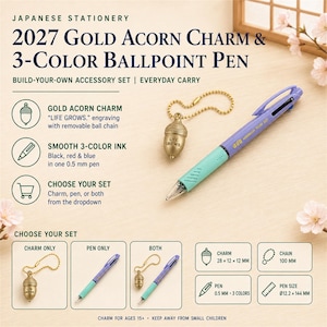 Op de afbeelding: Een goudkleurige eikelbedel met de inscriptie LIFE GROWS, bevestigd aan een gouden kogelketting, en een meerkleurige balpen met een lichtblauwe grip en paarse houder. De pen bevat zwarte, rode en blauwe inkt met een lijndikte van 0,5 mm.