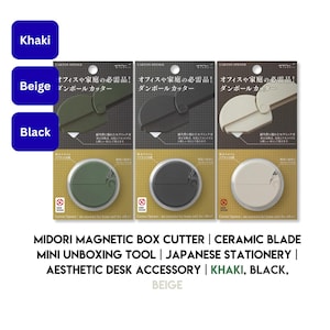 May include: Three Midori magnetic box cutters in khaki, black, and beige, each packaged on a card with Japanese text. These circular tools feature a ceramic blade and a magnetic back, designed for opening cartons in home or office settings.