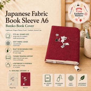 May include: A deep red fabric A6 book sleeve featuring an embroidered white cat playing with a ball of yarn. The cover includes a built-in bookmark cord with a small white cylindrical weight at the end. Text on the image includes Japanese Fabric Book Sleeve A6, Bunko Book Cover, and details about its features and available designs.
