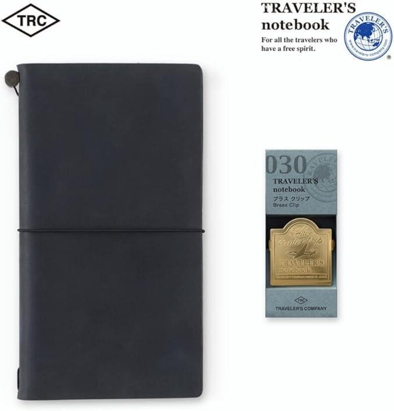 May include: A dark blue Traveler's notebook with a matching elastic closure. A brass clip is displayed next to the notebook. The packaging reads "TRAVELER'S notebook" and "Brass Clip".