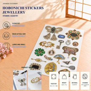 Peut inclure: Une feuille d'autocollants en PET transparent présentant divers motifs de bijoux de style vintage, notamment des broches, une clé et un éventail. La feuille affiche le texte HOBONICHI STICKERS JEWELLERY, CLEAR PET et une taille de 260 x 157 mm.