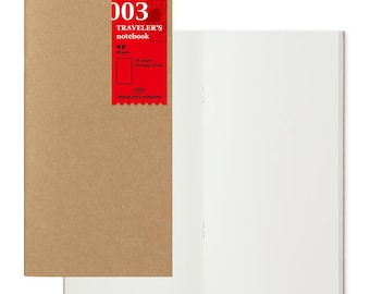 May include: A Traveler's Company notebook with a brown paper cover and a red label that says "003 Traveler's notebook Blank 64 pages MD Paper White Traveler's Company".