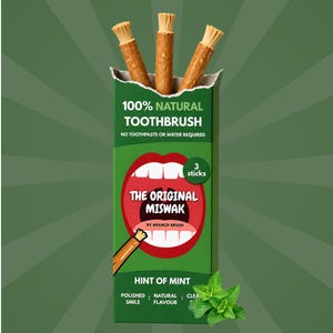 May include: A green box of "The Original Miswak" natural toothbrushes. The box features the text "100% Natural Toothbrush" and "Hint of Mint." Three brown miswak sticks are visible. A sprig of mint is in the lower right corner.