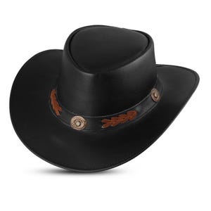 May include: A black leather cowboy hat with a brown leather band and decorative metal accents.