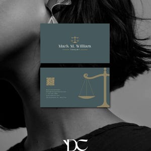 May include: Business cards for a lawyer, featuring a teal background with gold accents. The top card displays the name "Mark M. William" and the word "lawyer." The bottom card includes a scale graphic and contact information. The cards have a minimalist design.