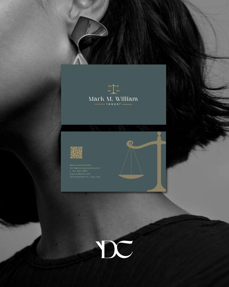 May include: Business cards for a lawyer, featuring a teal background with gold accents. The top card displays the name "Mark M. William" and the word "lawyer." The bottom card includes a scale graphic and contact information. The cards have a minimalist design.